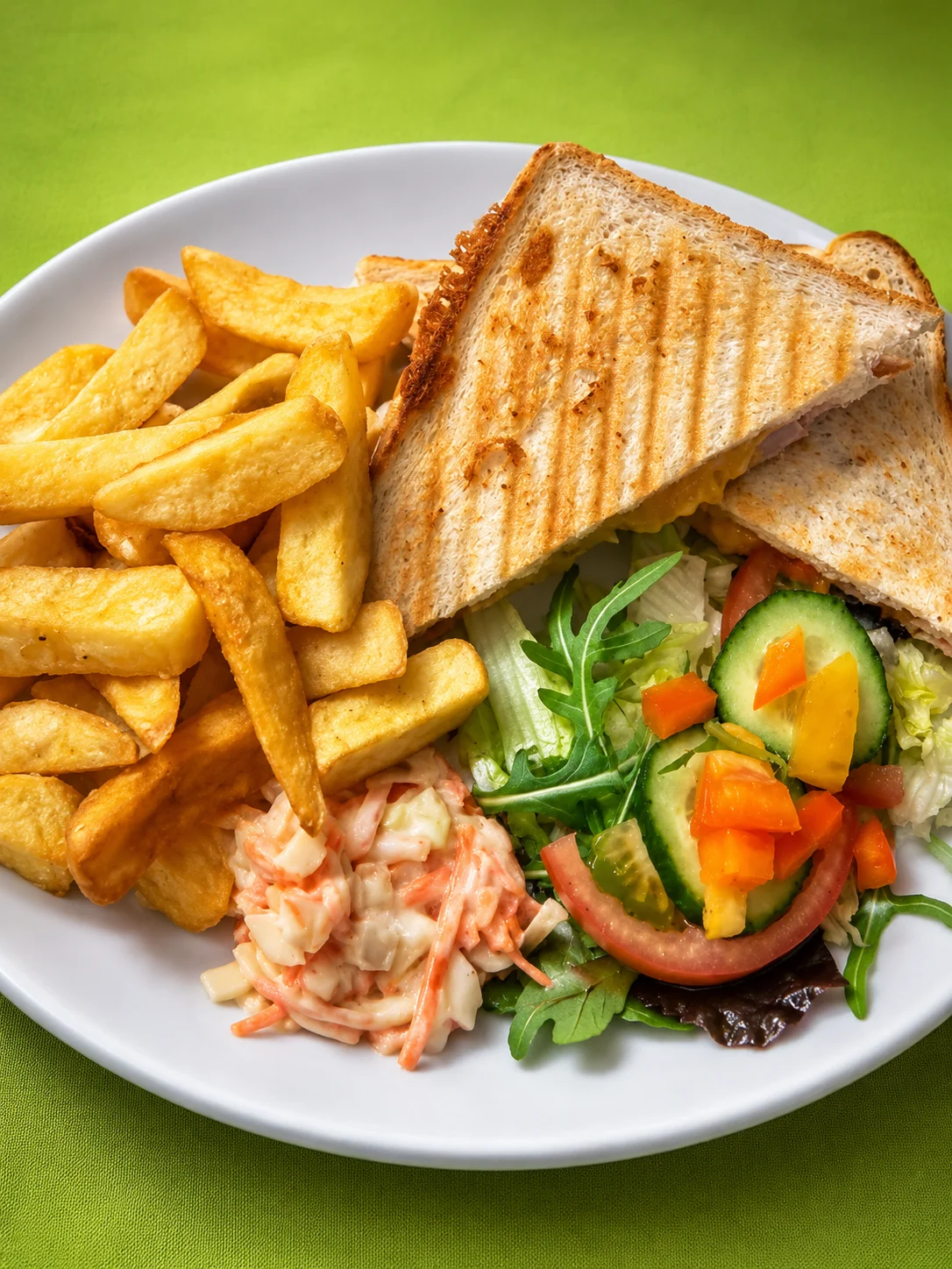 Toasted sandwich served with chips, coleslaw and salad
